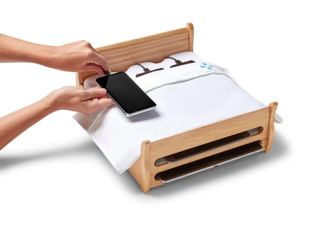 Arianna Huffington's Phone Bed Charging Station, brought to you by Thrive Global