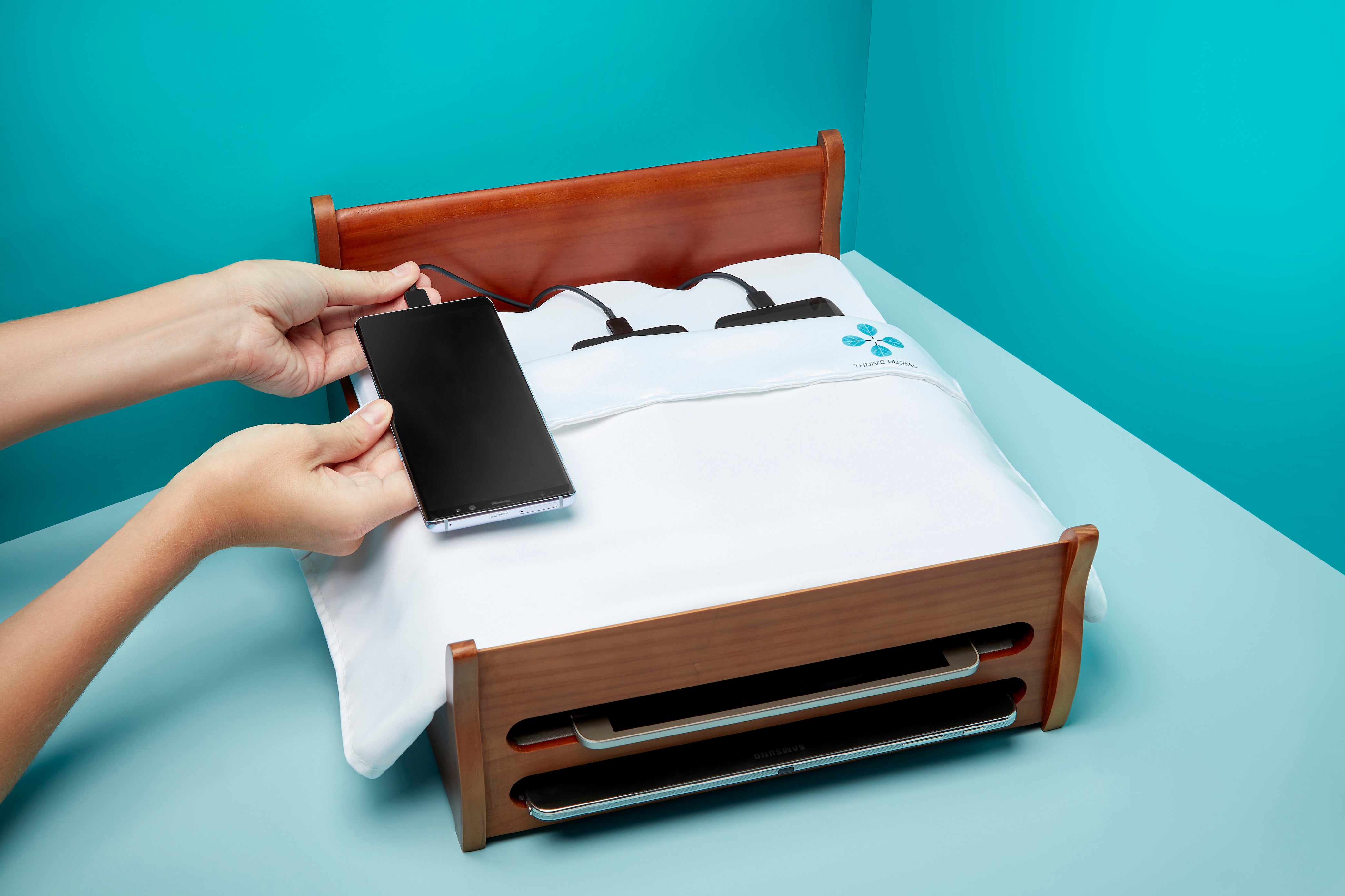 Arianna Huffington's Phone Bed Charging Station, brought to you by Thrive Global